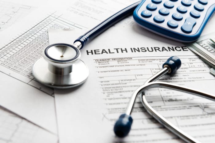 Health insurance papers with stethoscope