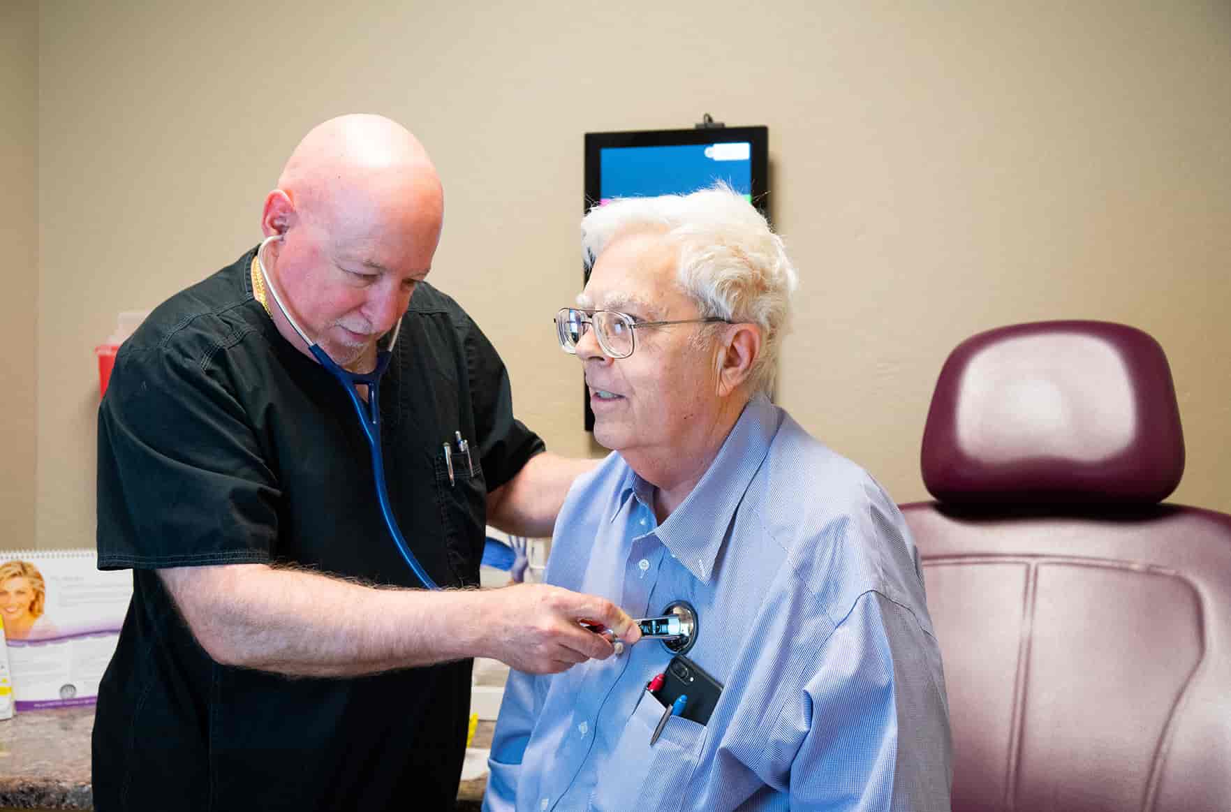 doctor checking patient heartbeat
